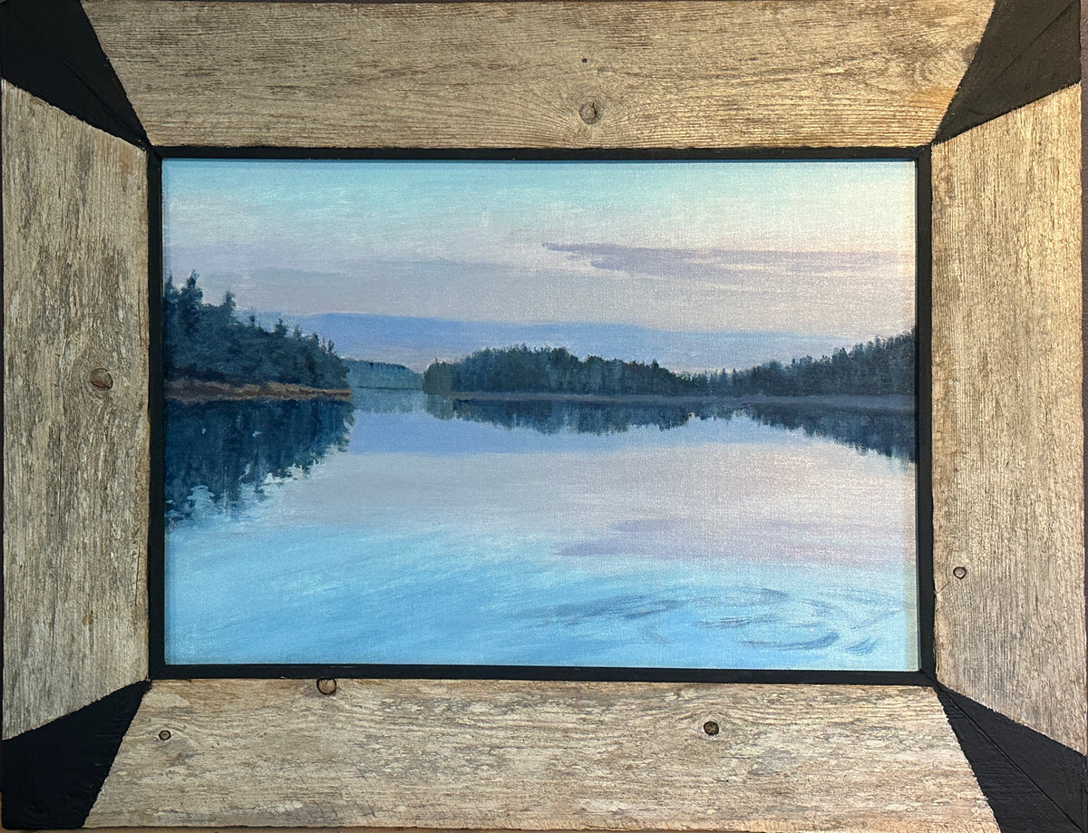 A framed landscape painting of a the Damariscotta River coves and canals with  the tall Spruce lined shores under a pale light of a dawn sky, set within a rustic reclaimed weathered white Cedar frame.