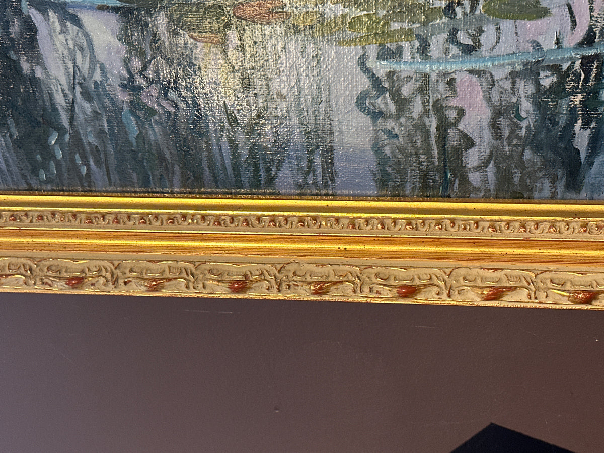 Close-up of an ornate gold picture frame with carved detailing, set against the painting featuring blue, gray, and green tones.